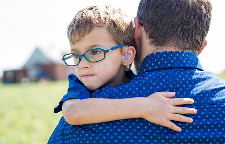 Social worker holding on to a young child 