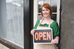 Entrepreneur holding an open sign 