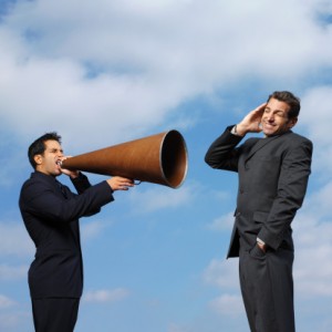 Man screaming through megaphone to another collegue 