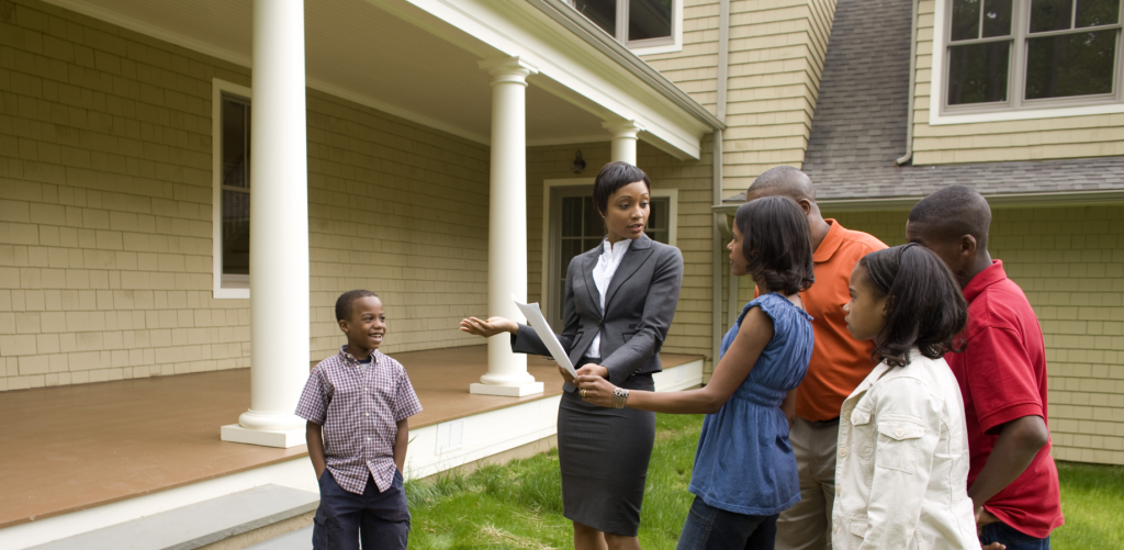 Real Estate agent presenting a house to a family 
