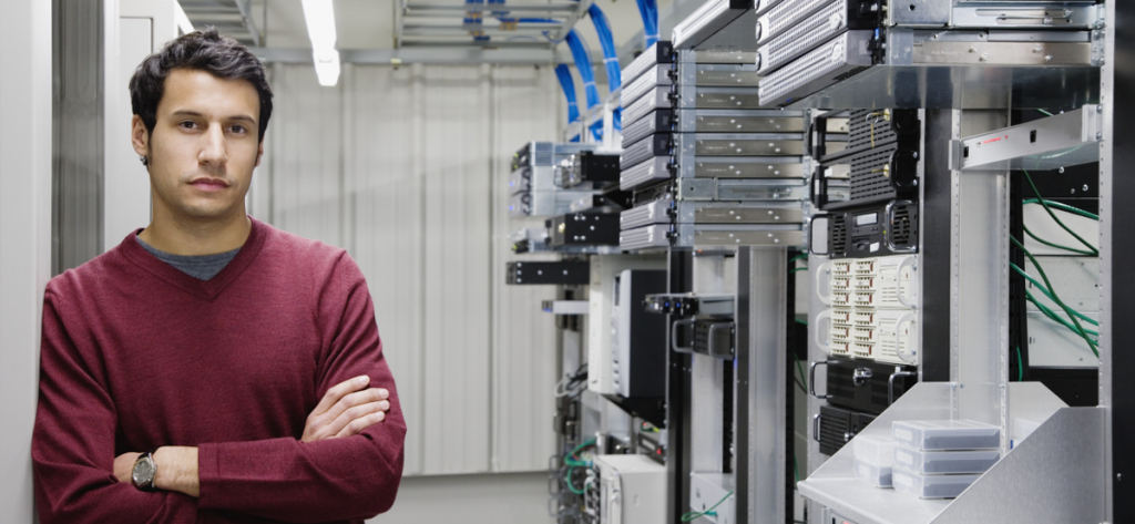 IT professional standing in a server room 